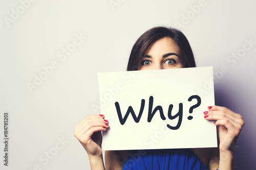 Girl holding a signboard with a question mark photo