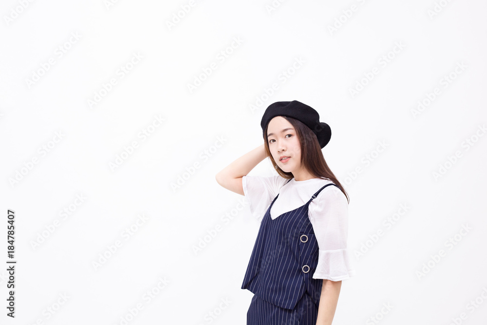 Young and pretty Asian female with artist hat smiling and posing in white isolated background Young and pretty Asian female with artist hat smiling and posing in white isolated background