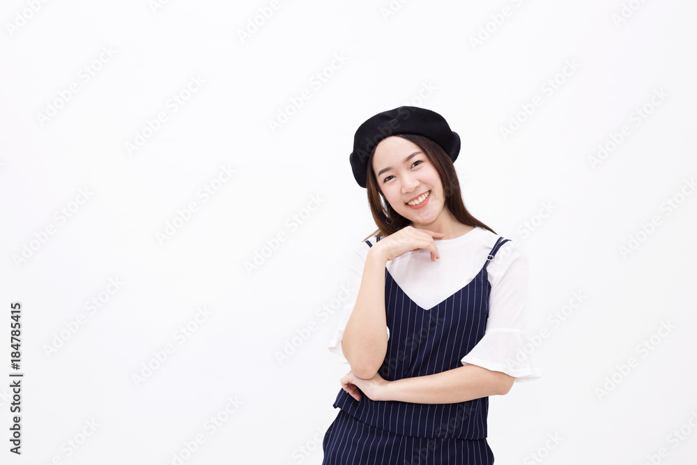 Young and pretty Asian female with artist hat smiling and posing in white isolated background Young and pretty Asian female with artist hat smiling and posing in white isolated background
