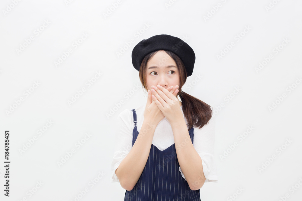 Asian female person covering her mouth in white isolated background. Asian female person covering her mouth in white isolated background.