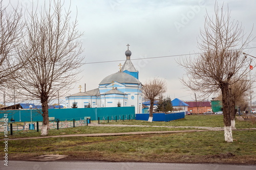 Monument of antiquity  - White-blue church of the holy apostles Peter and Paul (1824),  Uzhur, of Krasnoyarsk Territory, Russia. photo