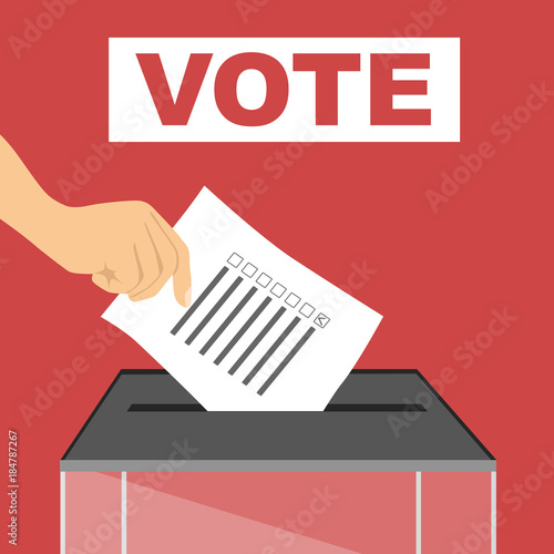 Hand of a person casting a ballot at a polling station during voting