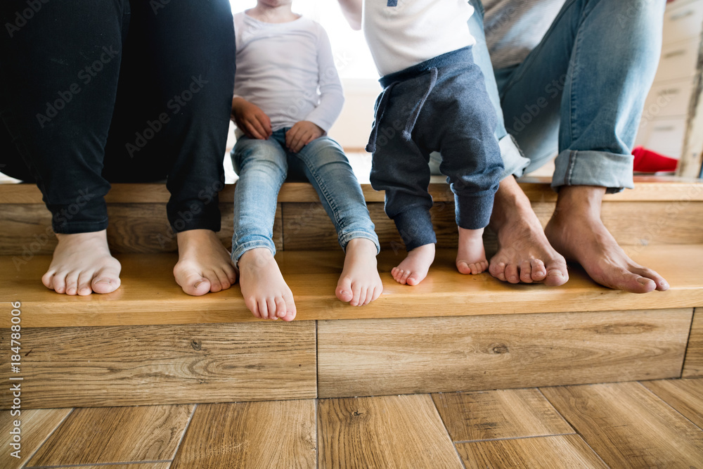 Beautiful young family. Bare feet of mother, father and children Beautiful young family. Bare feet of mother, father and children