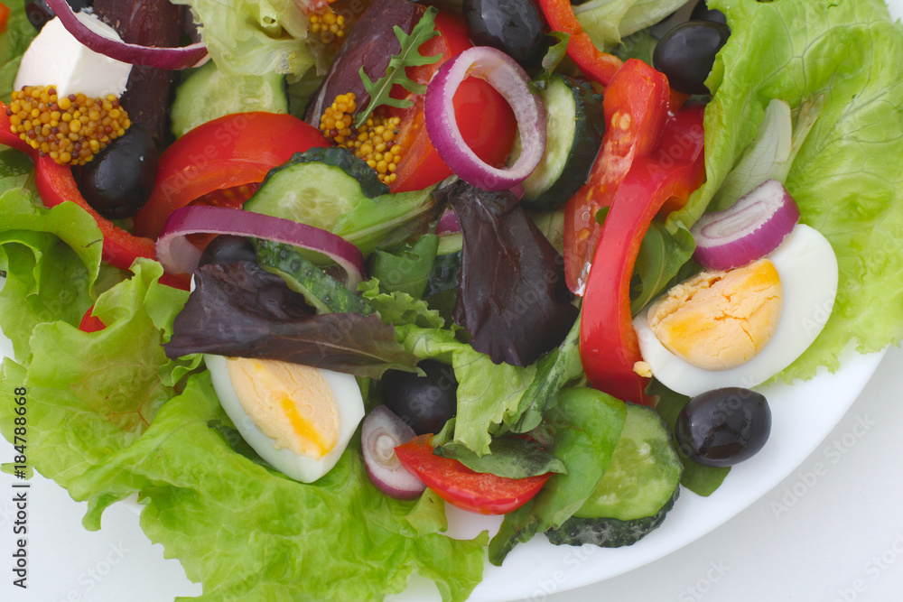 salad from fresh vegetables in a plate on a table, selective focus salad from fresh vegetables in a plate on a table, selective focus