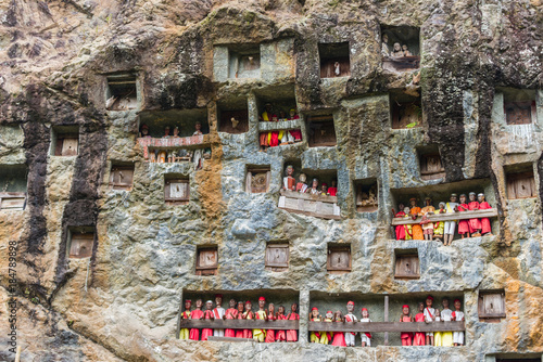 famous burial site with coffins placed in caves carved into the rock, guarded by the statues of the dead persons (called tau tau in local language). Tana Toraja, South Sulawesi