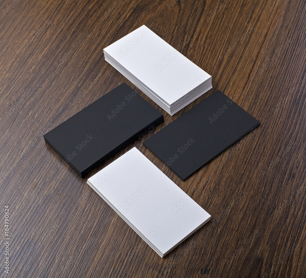 Mockup of white and black business cards at wooden background Mockup of white and black business cards at wooden background