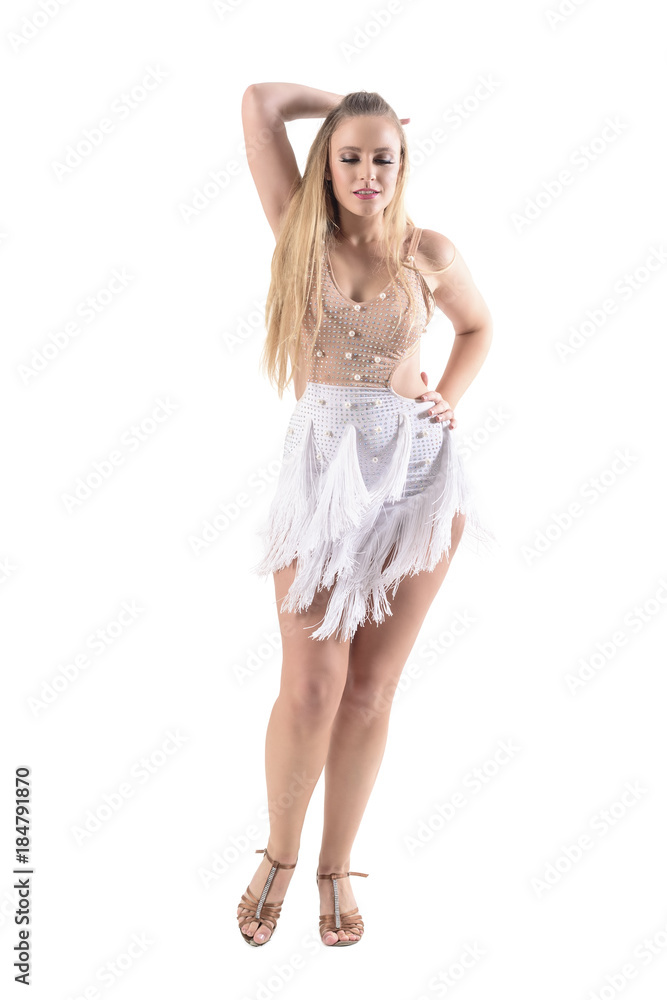 Graceful passionate elegant woman in dress dancing and looking down with hand in hair. Full body length portrait isolated on white background. 