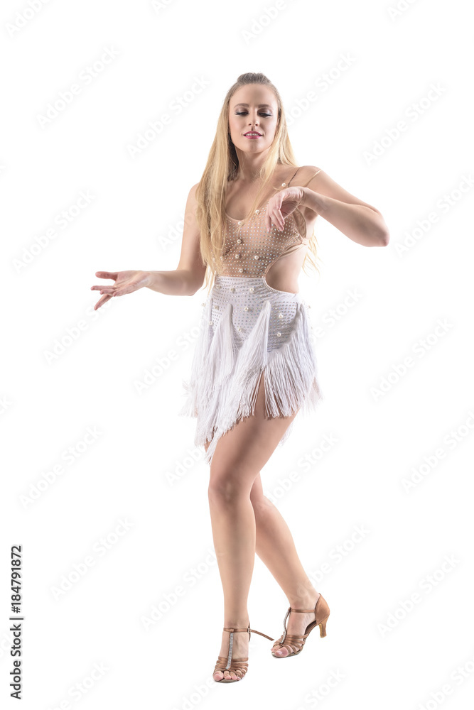Fototapeta premium Passionate woman dancer enjoying music moving gracefully with closed eyes. Full body length portrait isolated on white studio background. 