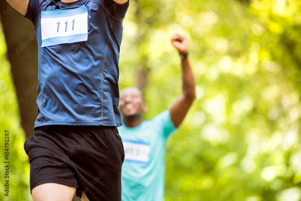 Fototapeta premium Unrecognizable young runners crossing the finish line.