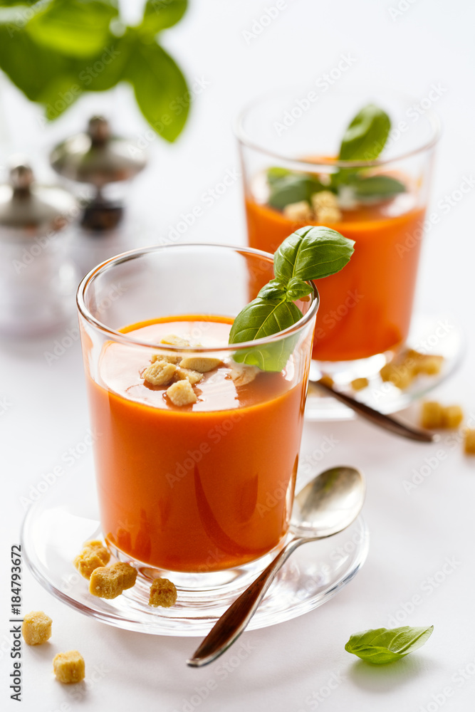 Glass with delicious homemade cream tomato soup with croutons. Healthy food concept. Glass with delicious homemade cream tomato soup with croutons. Healthy food concept.