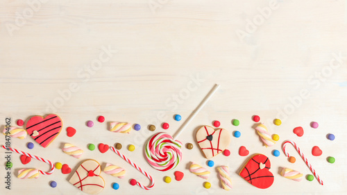 Colorful candies on white background, top view, copy space
