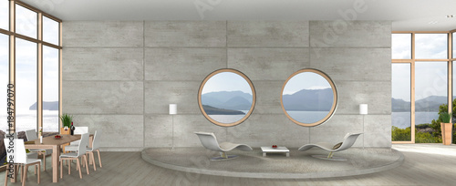 Fototapeta Nowoczesne wnętrze salonu z odkrytym betonem, okrągłymi oknami i widokiem na morze