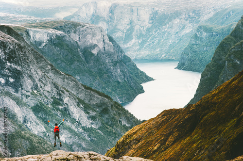 Jumping Man at Naeroyfjord mountains landscape Travel Lifestyle concept adventure active vacations outdoor hiking sport in Norway happy emotions