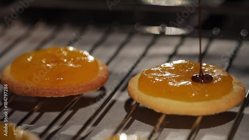 the biscuit is covered with chocolate glaze on the grate