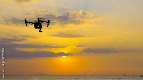 Professional camera drone flying on sea.