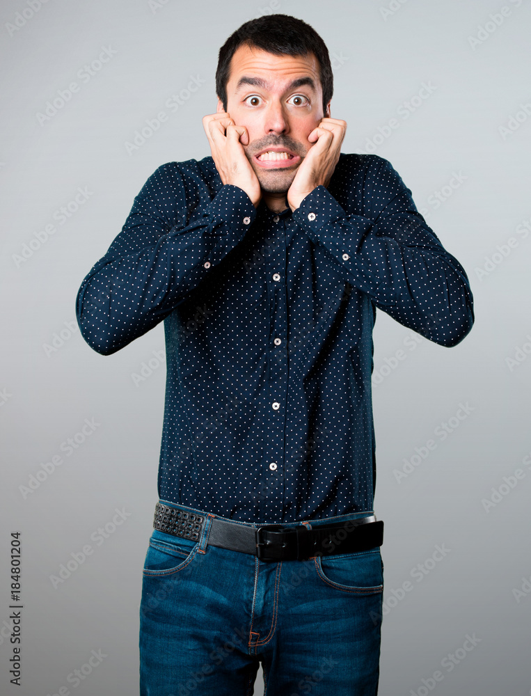 Frightened handsome man on grey background Frightened handsome man on grey background