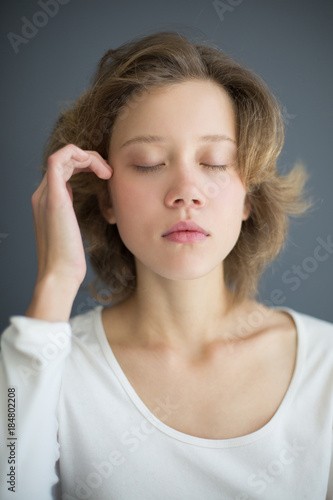 Portrait of sensual beautiful woman thoughtfully closing her eyes isolated