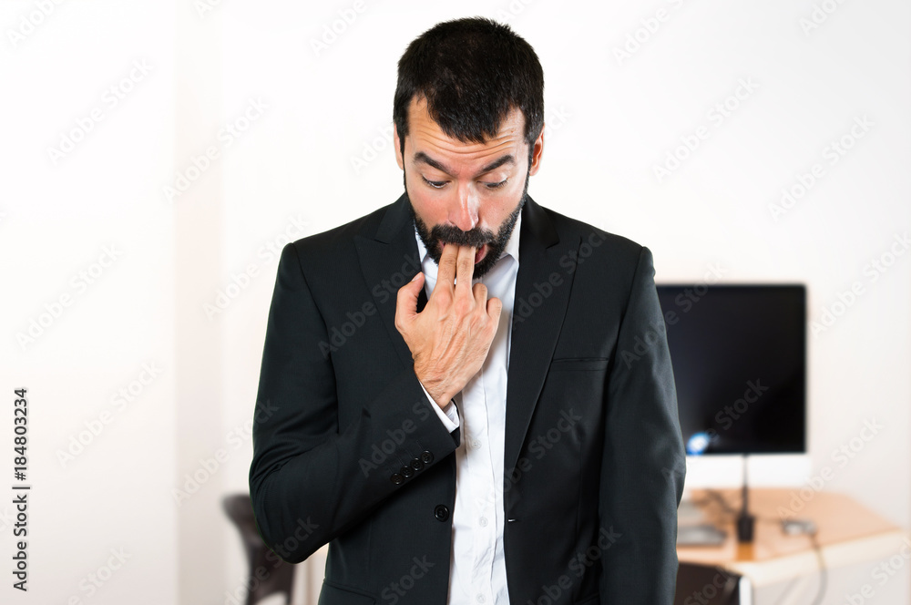 Handsome businessman making vomiting gesture in the office Handsome businessman making vomiting gesture in the office