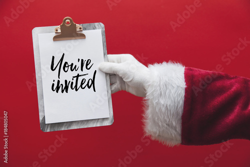 Wallpaper Mural Santa Claus hand holding a clipboard with Christmas message page Torontodigital.ca