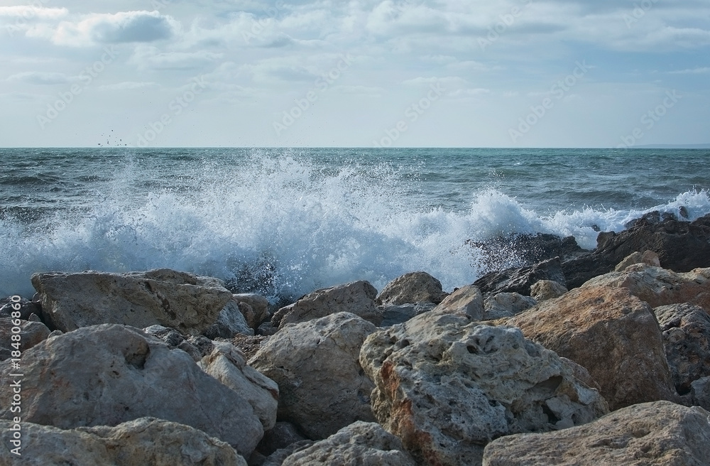Waves splash onto rocks