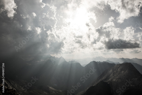 Mountain landscape with storm clouds and sunshine
