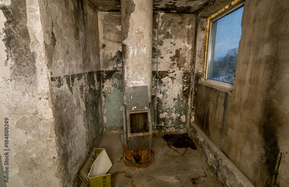 Awful garbage chute in apartment building with cheap apartments. This type of building is called