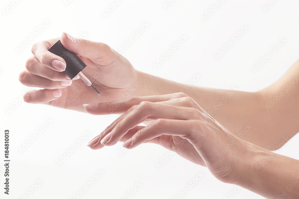 Woman in a nail salon receiving manicure by a beautician. Beauty treatment concept... Woman in a nail salon receiving manicure by a beautician. Beauty treatment concept...