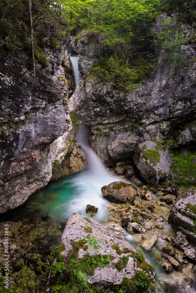 Nemclja waterfall below a natural bridge in Moznica Gorges in Soca (Trenta) valley, Slovenia. Nemclja waterfall below a natural bridge in Moznica Gorges in Soca (Trenta) valley, Slovenia.