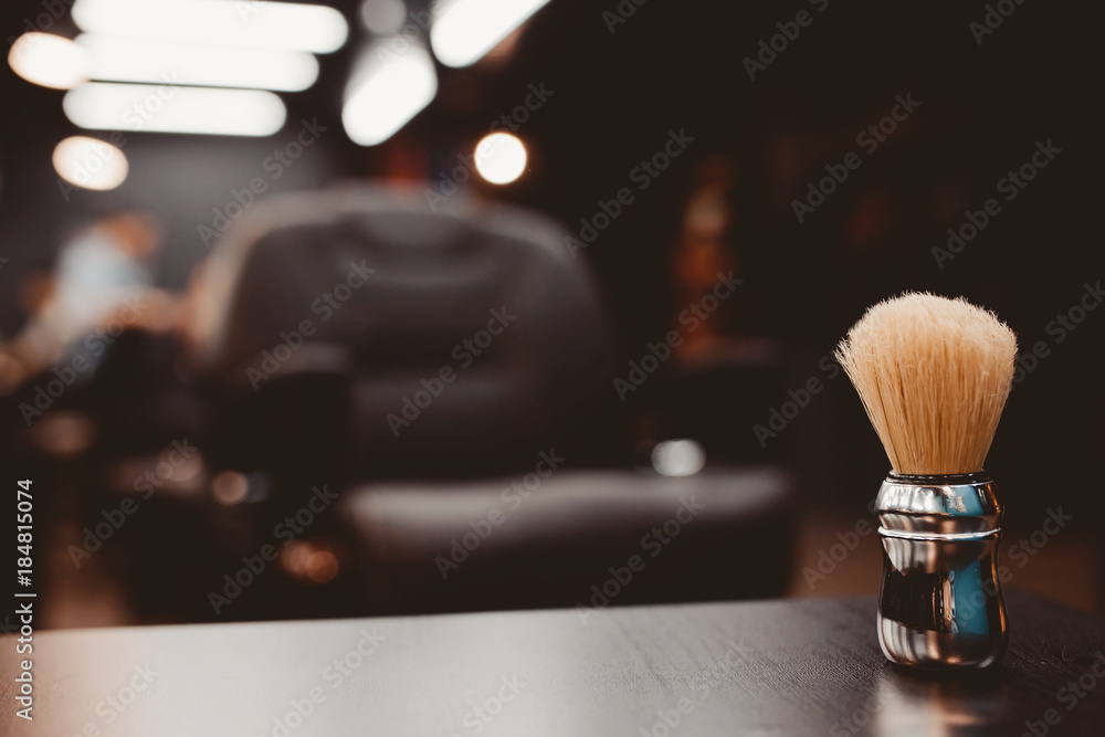 brush for shaving beard along with bowl, blurred background of hair salon  for men, barber shop Stock Photo | Adobe Stock