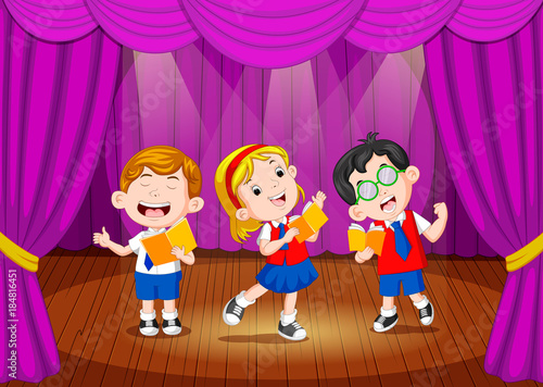 school children singing on the stage