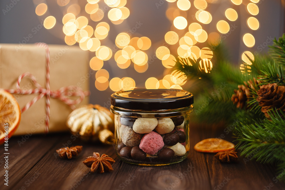 Assortment of handmade candies in glass jar with Christmas decorations and bokeh Assortment of handmade candies in glass jar with Christmas decorations and bokeh