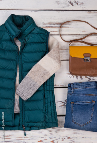 Quilted vest, jeans and purse