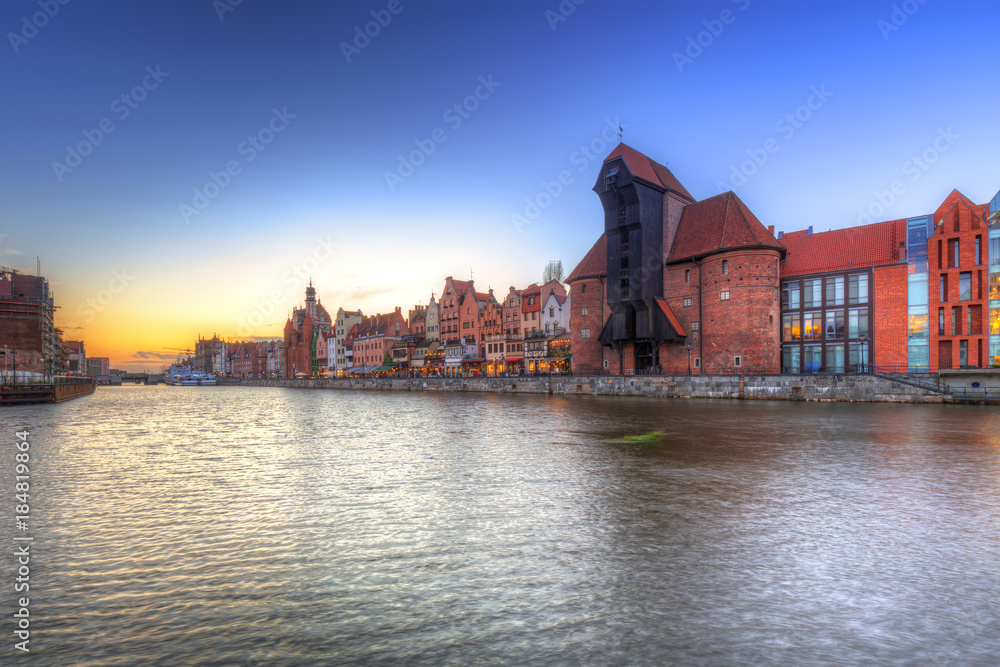 Gdansk at sunset with historic port crane reflected in Motlawa river, Poland