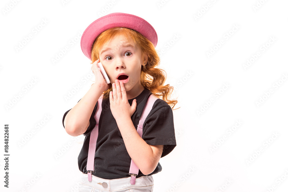 surprised red hair kid talking by smartphone isolated on white surprised red hair kid talking by smartphone isolated on white