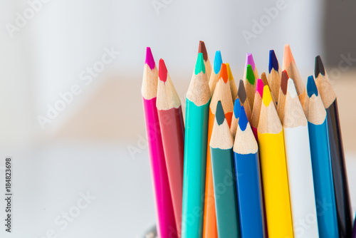 Wooden coloured pencils in office cup