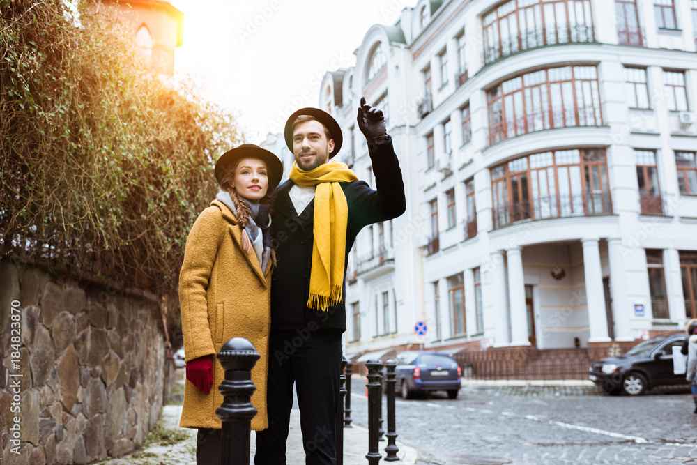 Obraz premium young beautiful couple catching taxi on city street