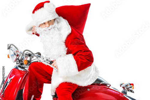 Santa Claus with big red bag riding red scooter, isolated on white