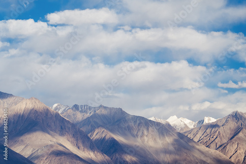 Closeup image of mountains and blue sky with clouds background in Ladakh , India © Farknot Architect