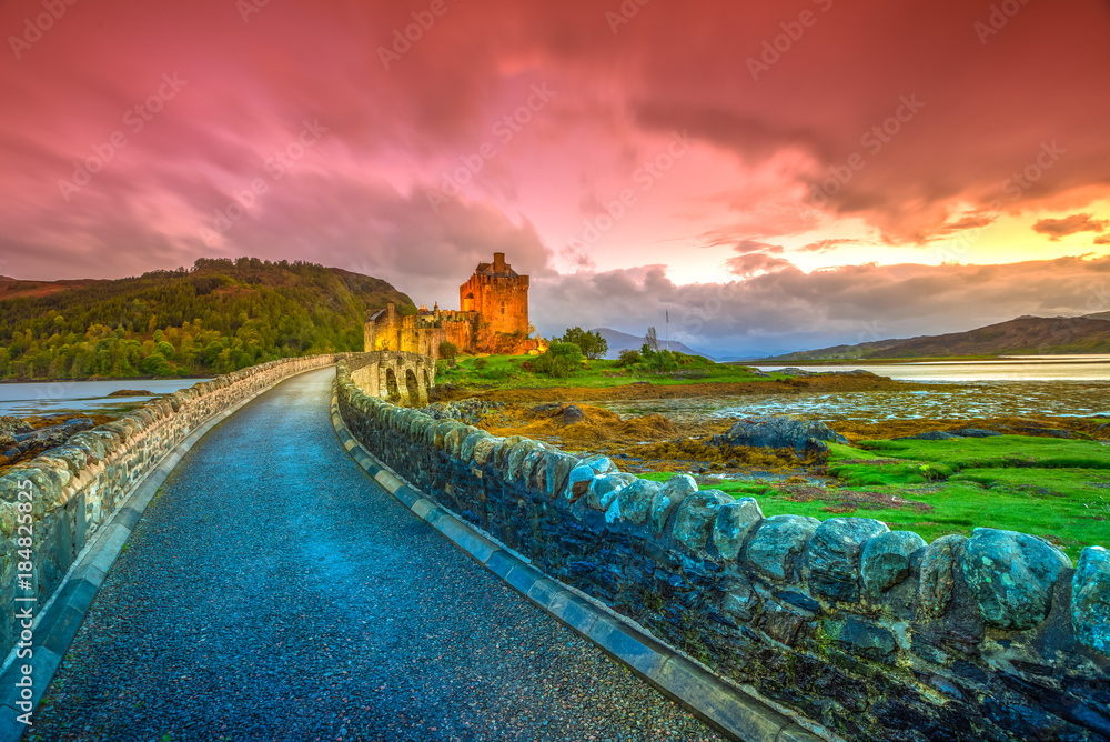 Colorful sunset and twilight on Eilean Donan, 13th Century Castle of United Kingdom. Located in Dornie village in the Highlands of Scotland.
