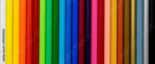 Colorful coloring pencils on rainbown gradient pattern and texture background