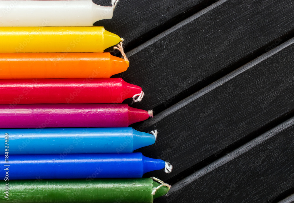 custom made wallpaper toronto digitalMany colorful candles in a single row and line, black background, candles of vibrant white. yellow, orange, red and blue colors, in a rainbow gradient