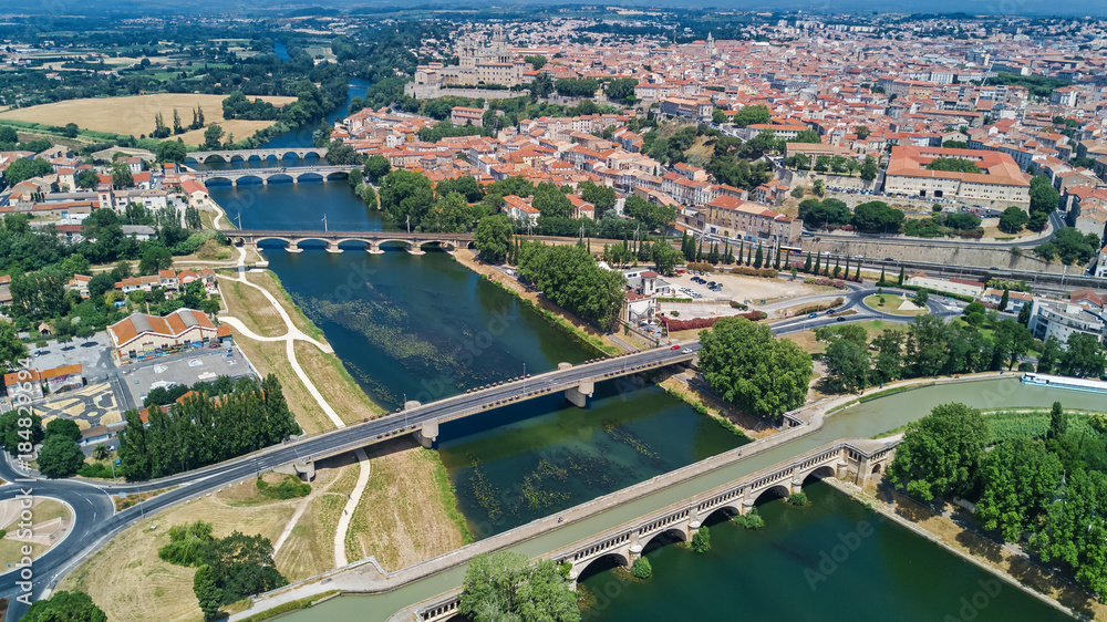 Aerial top view of Beziers town, river and bridges from above, South France
