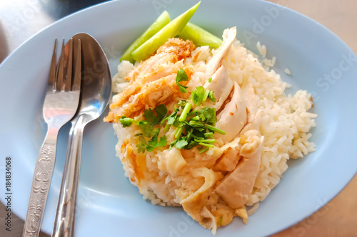 Seletive focus on vegetable of Thai traditional food (Khao-Mun-Kai). Chicken rice with Chicken fried crispy.