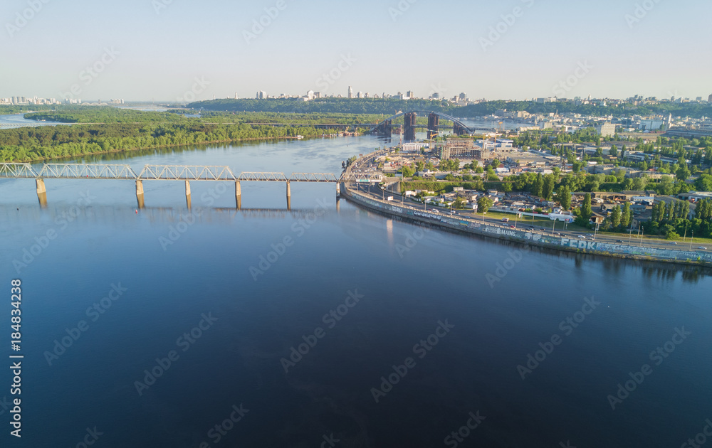 Aerial top view of Dnepr river and Rybalskiy island from above, bridges and skyline of Kiev city, Ukraine
