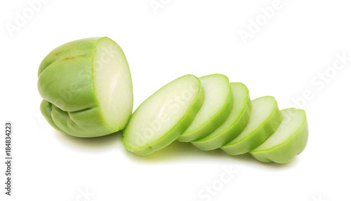 A chayote squash that has been cut in half on a white background. photo