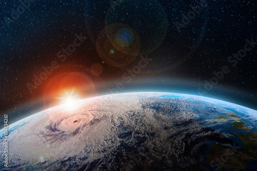 Fototapeta Naklejka Na Ścianę i Meble -  Dawn over the planet. A view from outer space to the surface of the Earth. Hurricane over the ocean. Elements of this image furnished by NASA