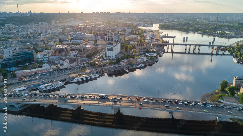 Obraz premium Aerial top view of Dnepr river and Rybalskiy island from above, bridges and skyline of Kiev city, Ukraine