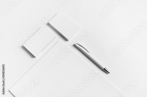 Blank stationery set. Letterhead, business cards and pen on white paper background.