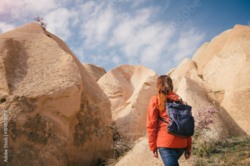 Rocks and blue sky of Cappadocia and a female backpacker