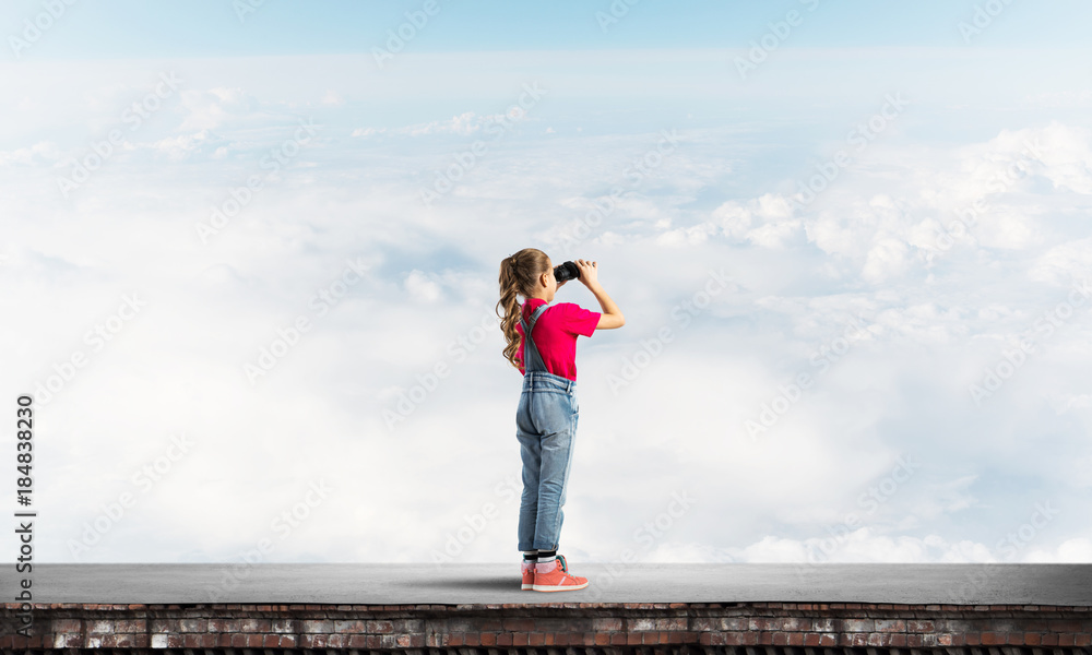 Concept of careless happy childhood with girl of school age looking in future Concept of careless happy childhood with girl of school age looking in future